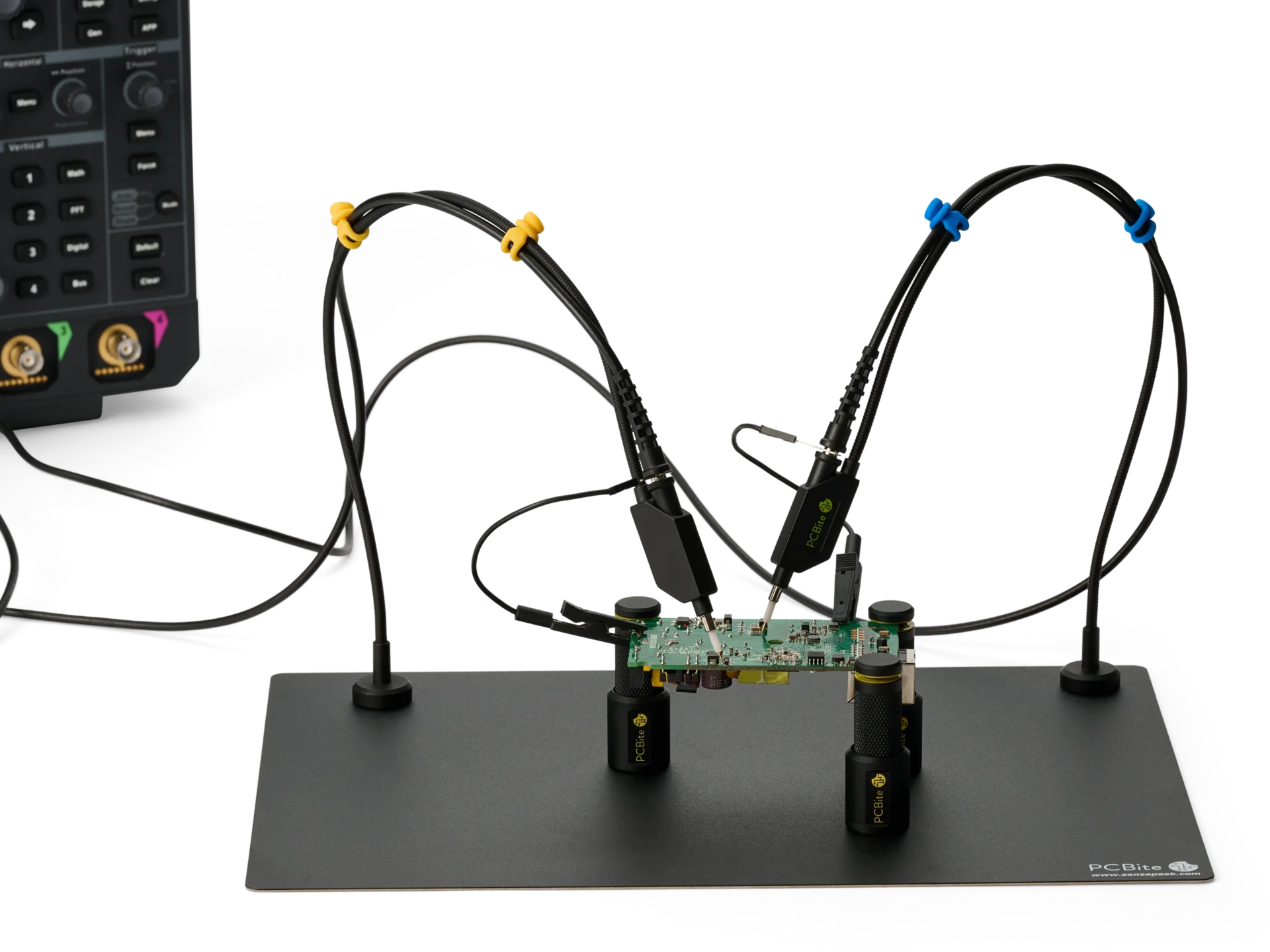 Two handsfree oscilloscope probes with long ground leads clipped on, measuring a PCB in PCBite holders for an oscilloscope.