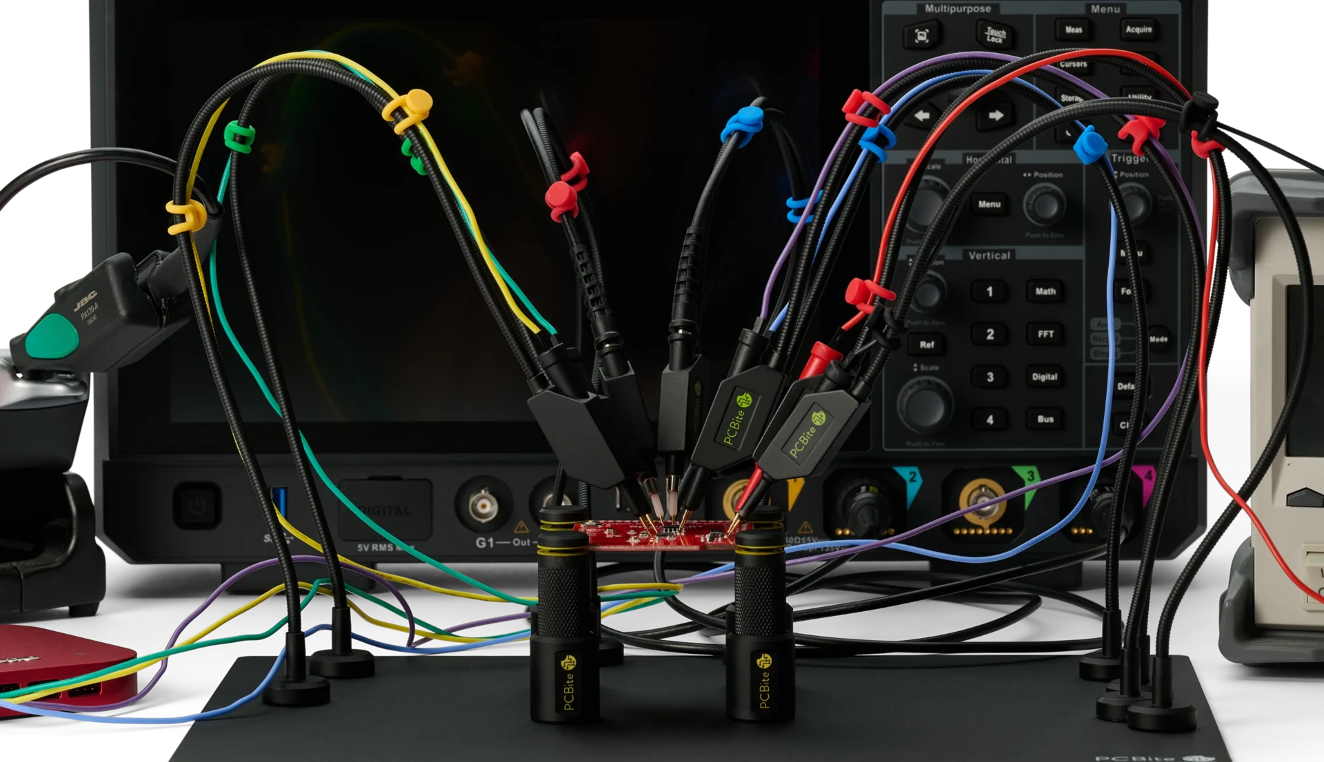 SQ oscilloscope probes and color-coded SQ10 handsfree probes on one PCB in PCBite holders, connected to a mixed signal oscilloscope.