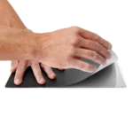 Hands applying the A4 sized insulation cover on the large baseplate (PCBITE-4017)