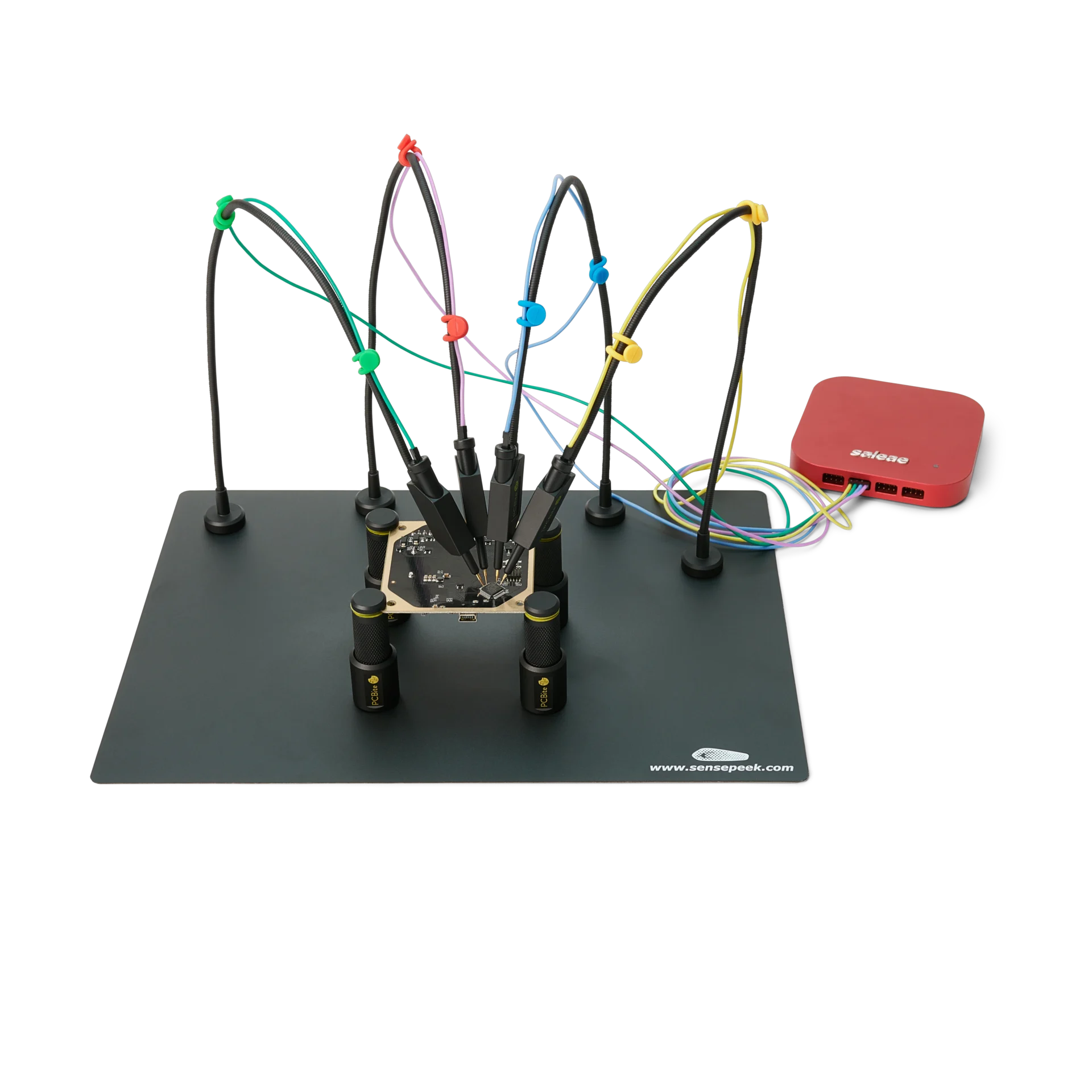Four handsfree SQ10 probes with color-coded cable holders measuring finepitch IC on PCB (PCBITE-6003)