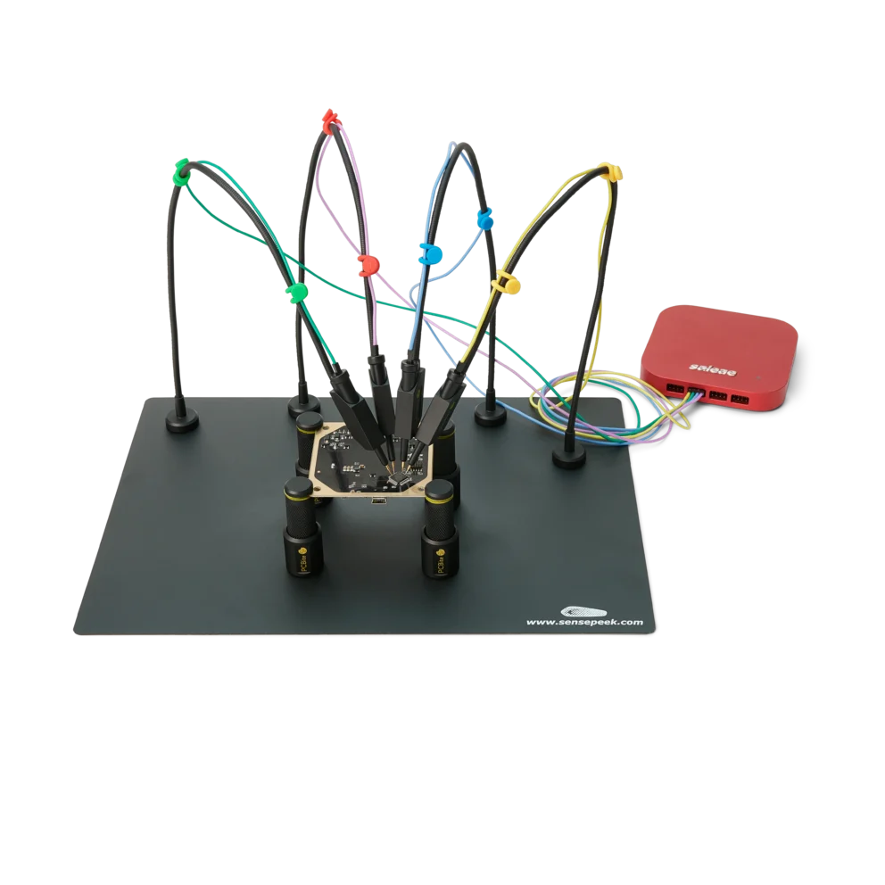 Four handsfree SQ10 probes with color-coded cable holders measuring finepitch IC on PCB (PCBITE-6003)