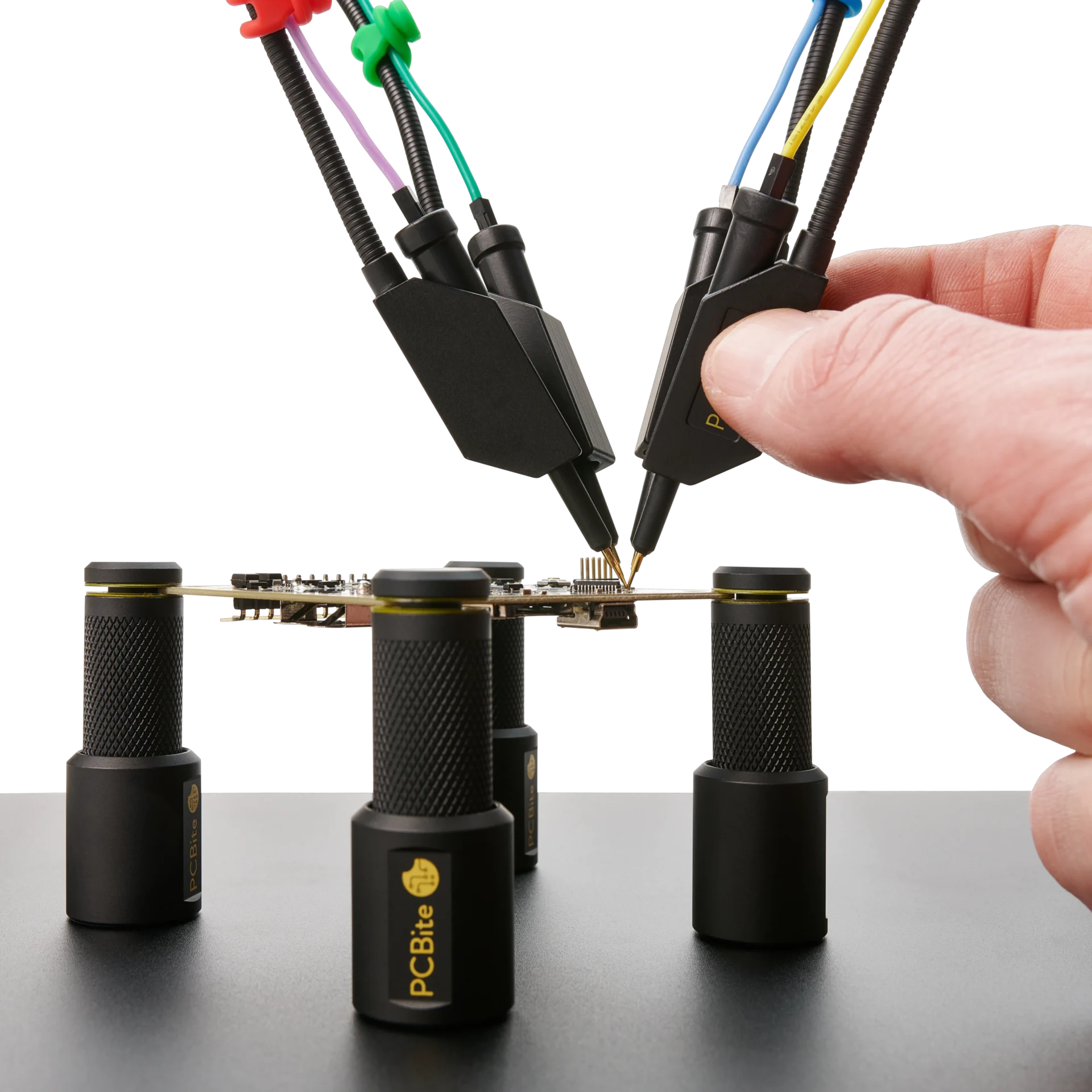 Hand placing fourth handsfree SQ10 probe on PCB under test held by PCB holders (PCBITE-6003)