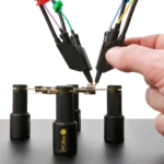 Hand placing fourth handsfree SQ10 probe on PCB under test held by PCB holders (PCBITE-6005)
