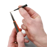 Hands showing how to change the replaceable spring-loaded test needle of the SQ10 probe (PCBITE-6005)