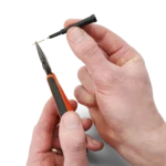 Hands showing how to change the replaceable spring-loaded test needle of the SQ10 probe (PCBITE-6011)