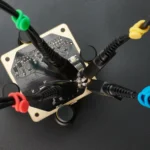 Four handsfree SQ100 100 MHz oscilloscope probes measuring on PCB with different color-coded cable holders (PCBITE-6013)