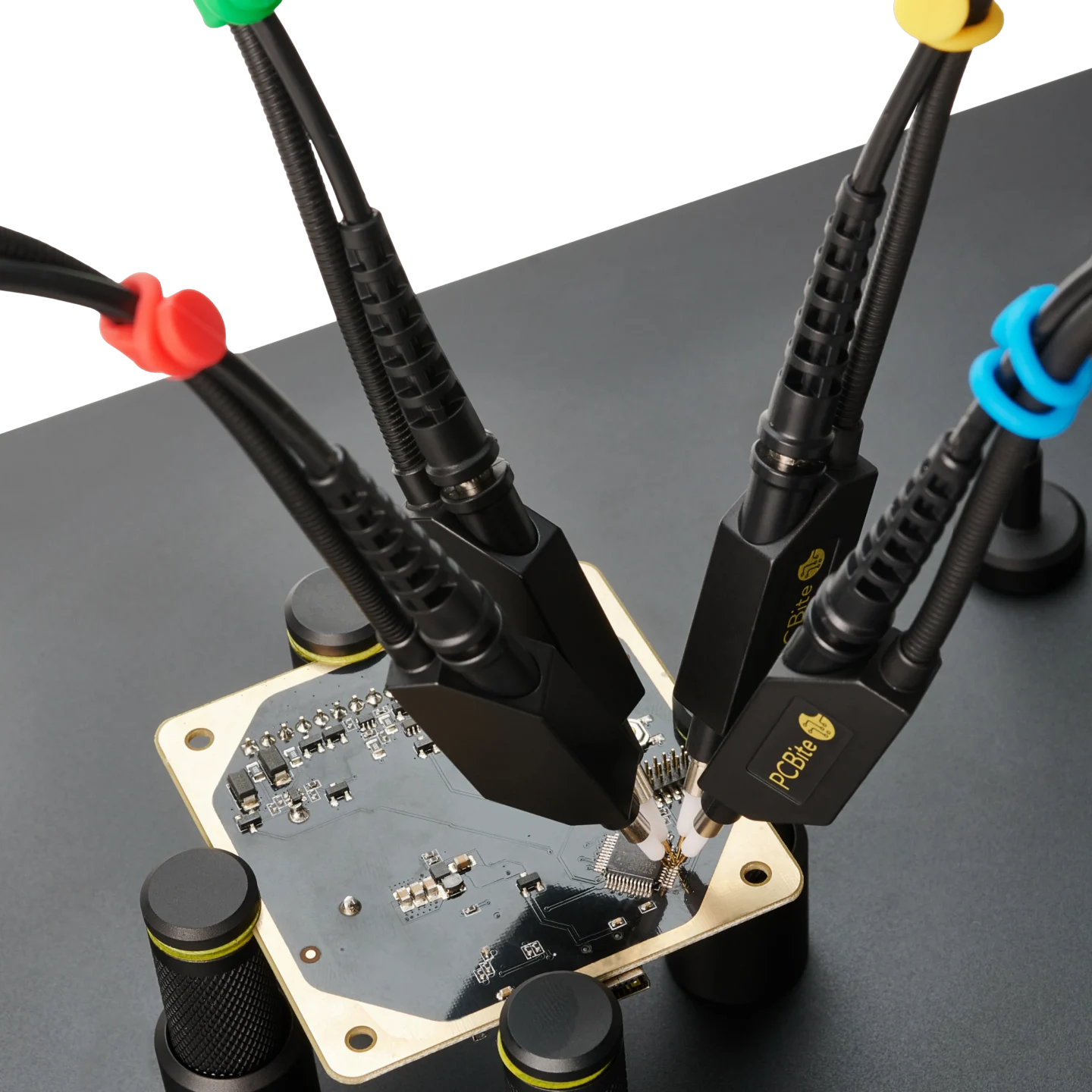 Four handsfree SQ500 500MHz oscilloscope probes measuring close signal pins on MCU test PCB (PCBITE-6024)