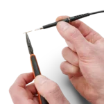 Hands showing how to change the replaceable spring-loaded test needle of the SQ350 350 MHz oscilloscope probe (PCBITE-6025)