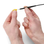 Hand showing how to mount or dismount the probe protection from the SQ500 500 MHz oscilloscope probe (PCBITE-6026)