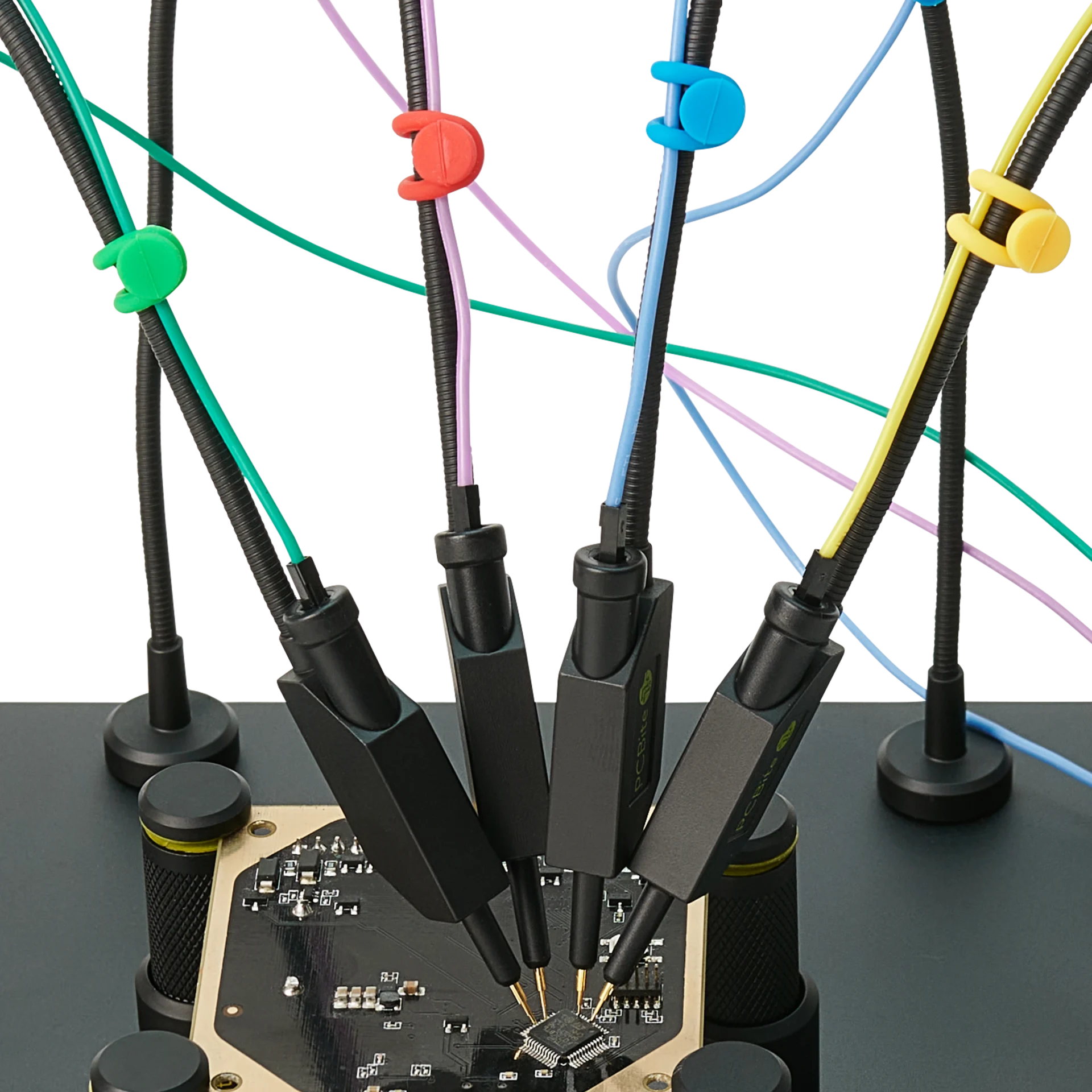 Four handsfree SQ10 probes with spring-loaded tips probing PCB signals with color-coded cable holders (PCBITE-6027)