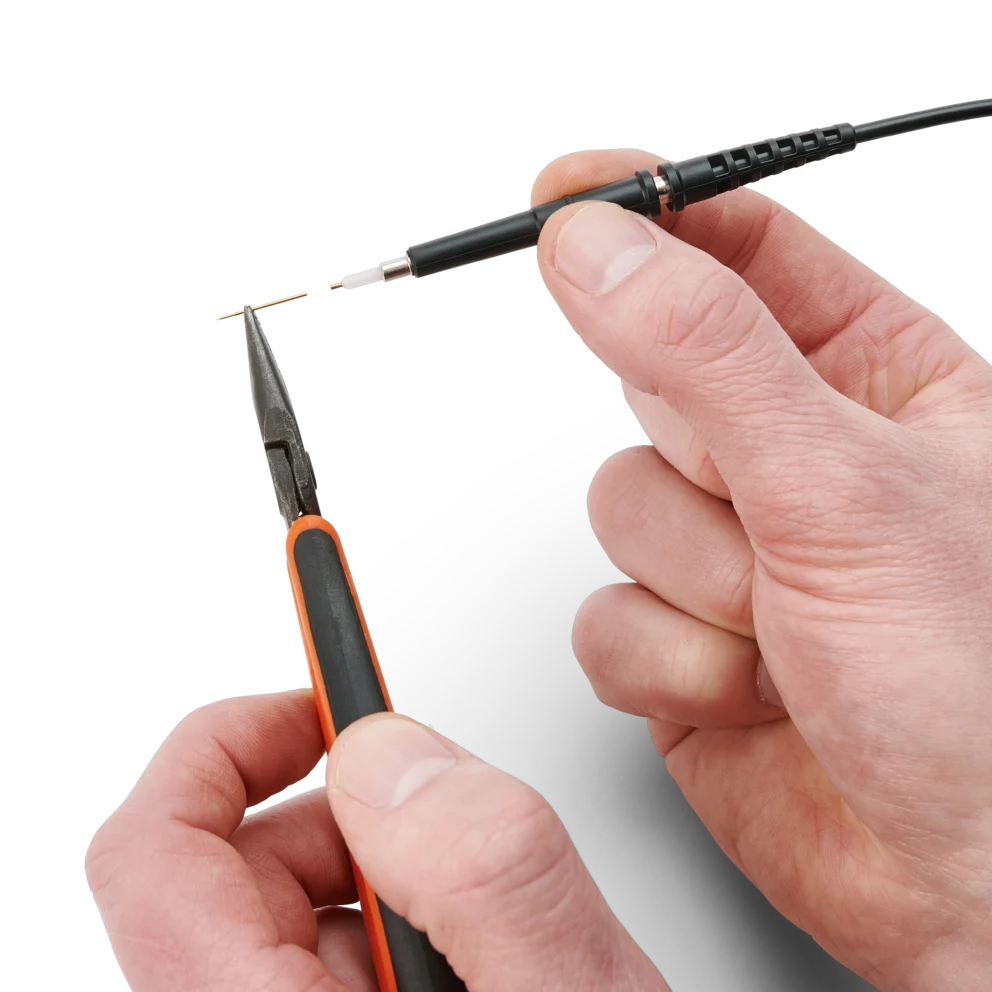 Hands showing how to change the replaceable spring-loaded test needle of the oscilloscope probe (PCBITE-7002)