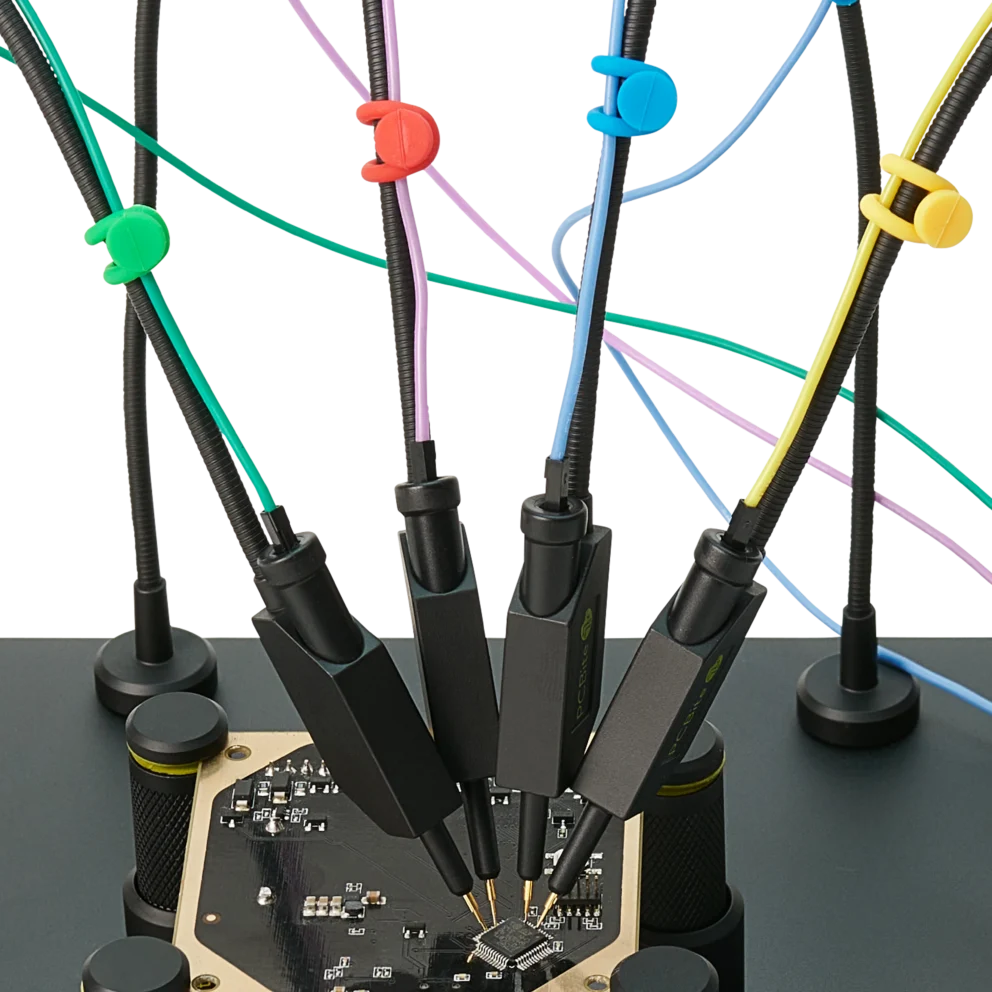 Four handsfree probes with color-coded cable holders measuring finepitch IC on PCB (PCBITE-7006)