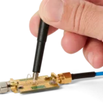 Hand measuring on RF PCB using SQG15 1.5 GHz probe with ground spring for handheld measuring (PCBITE-7008)