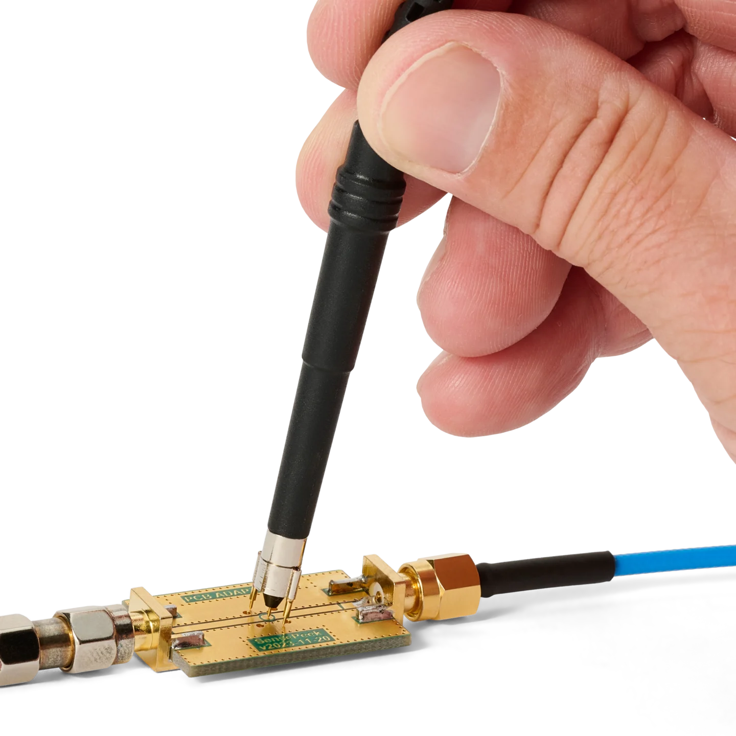 Hand measuring on PCB using SQG60 6.0 GHz probe with mounted dual ground spring (PCBITE-7012)