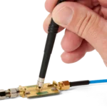 Hand measuring on PCB using SQG60 6.0 GHz probe with mounted dual ground spring (PCBITE-7013)