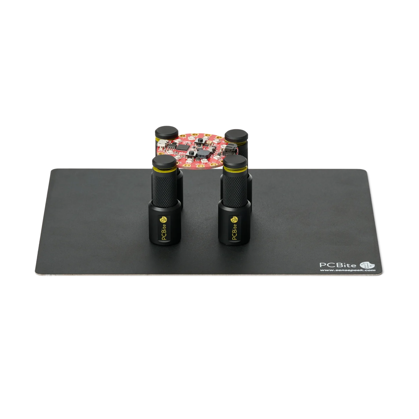 Set of four magnetic spring-loaded PCB holders on a small insulated baseplate holding a PCB (PCBITE-7025)