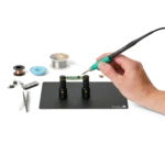 Hand soldering PCB held by two magnetic spring-loaded PCB holders on the small insulated baseplate (PCBITE-7025)