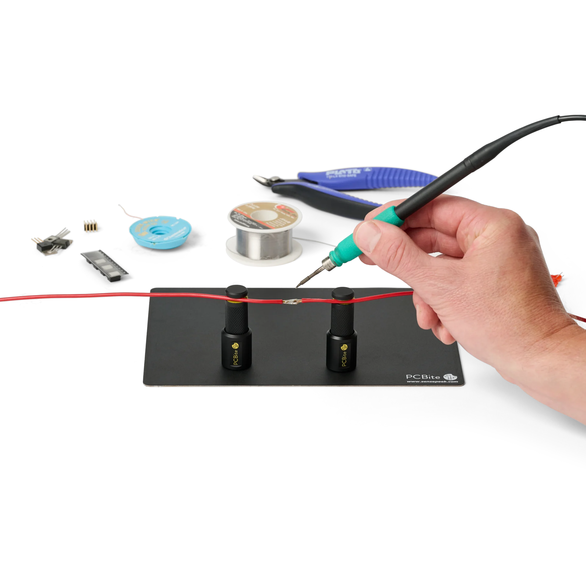 Hand soldering wire held by two magnetic spring-loaded PCB holders on the small insulated baseplate (PCBITE-7025)