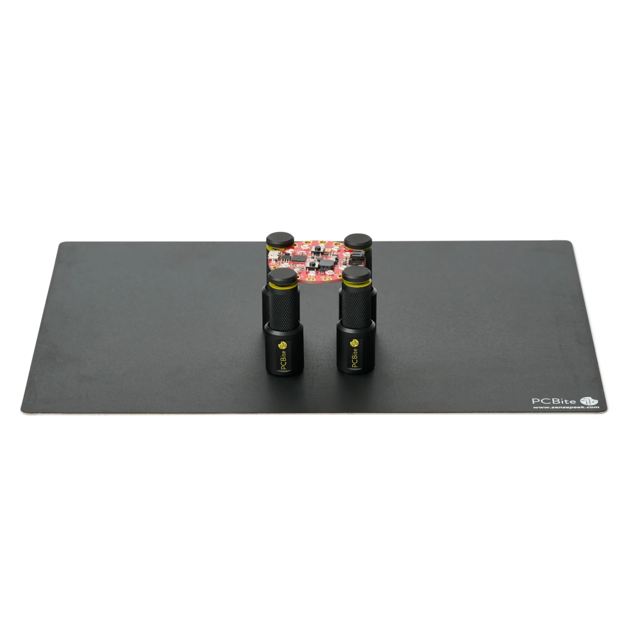 Set of four magnetic spring-loaded PCB holders on a large insulated baseplate holding a PCB (PCBITE-7026)