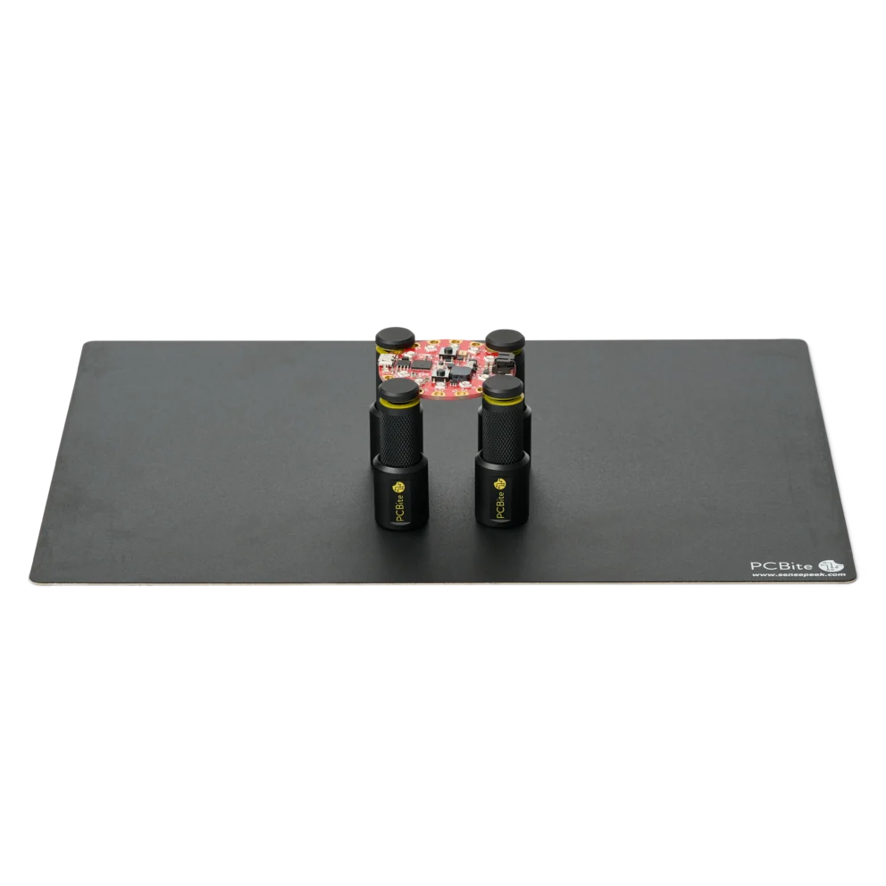 Set of four magnetic spring-loaded PCB holders on a large insulated baseplate holding a PCB (PCBITE-7026)