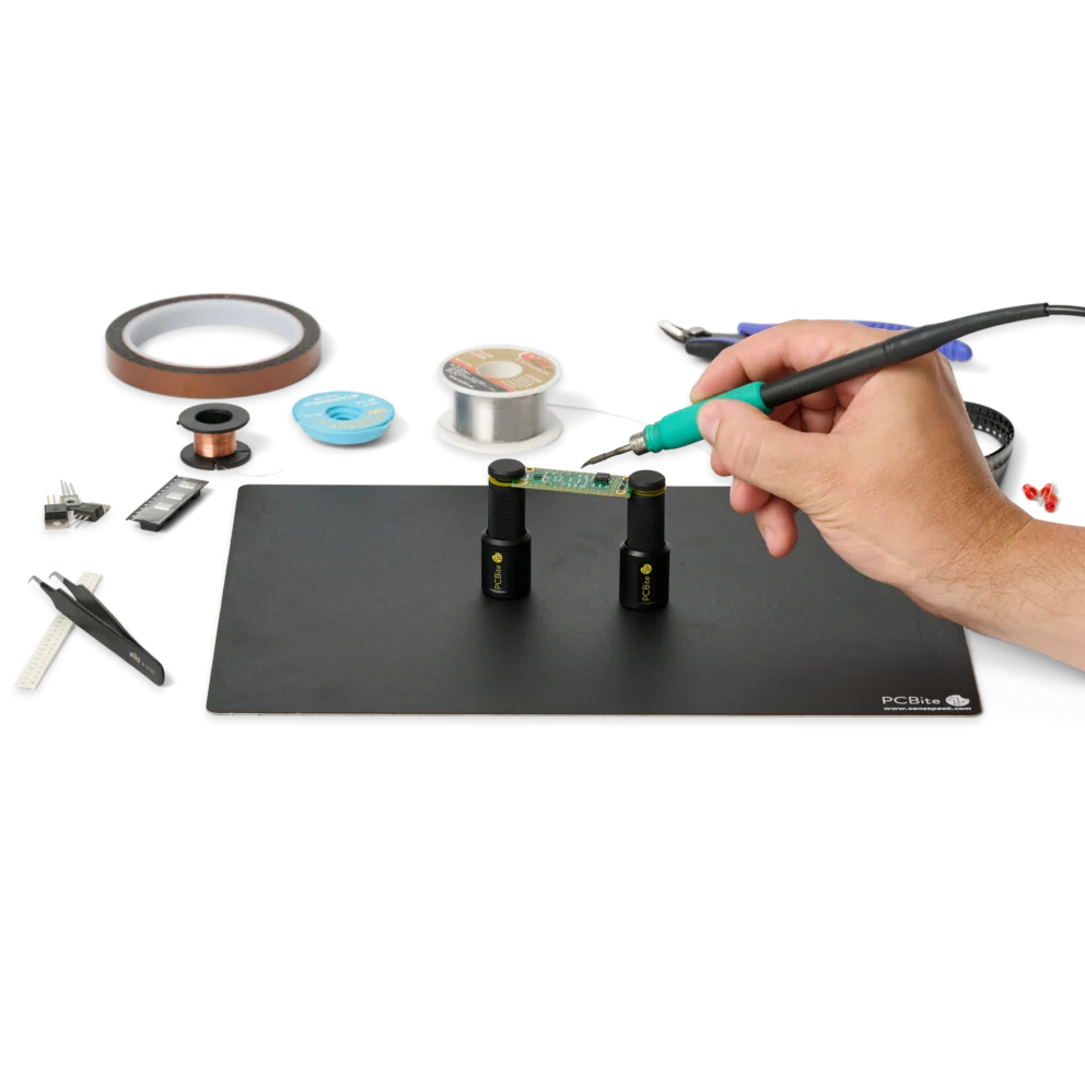 Hand soldering PCB held by two magnetic spring-loaded PCB holders (PCBITE-7026)