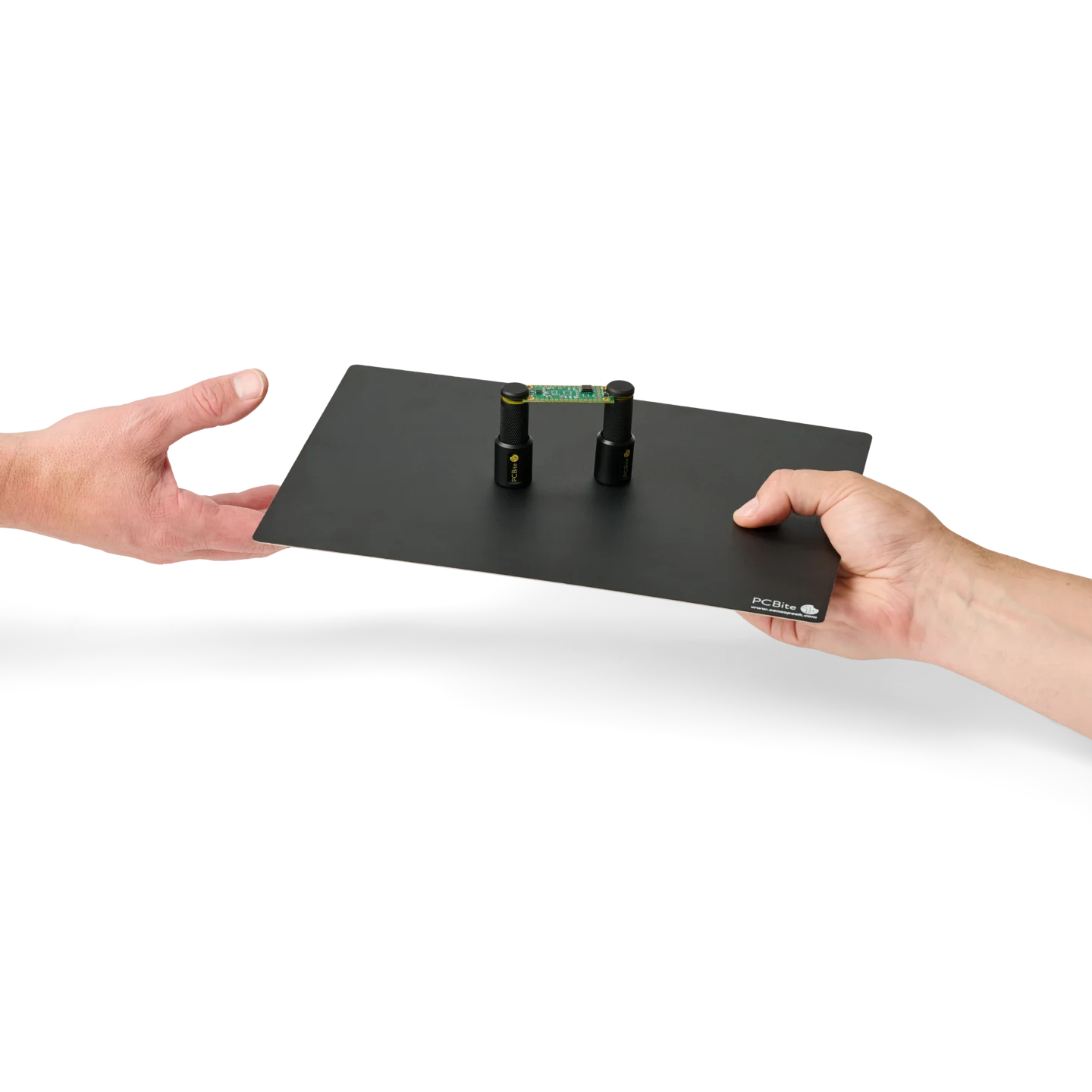 SP10, Hand receiving a setup with two spring-loaded PCB holders on a large insulated baseplate (PCBITE-7028)