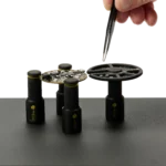 Hand picking components with tweezer from the component tray held by a PCB holder (PCBITE-7029)