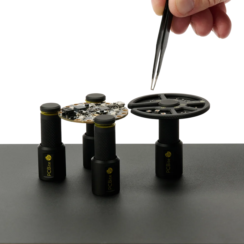 Hand picking components with tweezer from the component tray held by a PCB holder (PCBITE-7029)