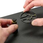 Hand opening a PCB holder and another holding the component tray (PCBITE-7029)