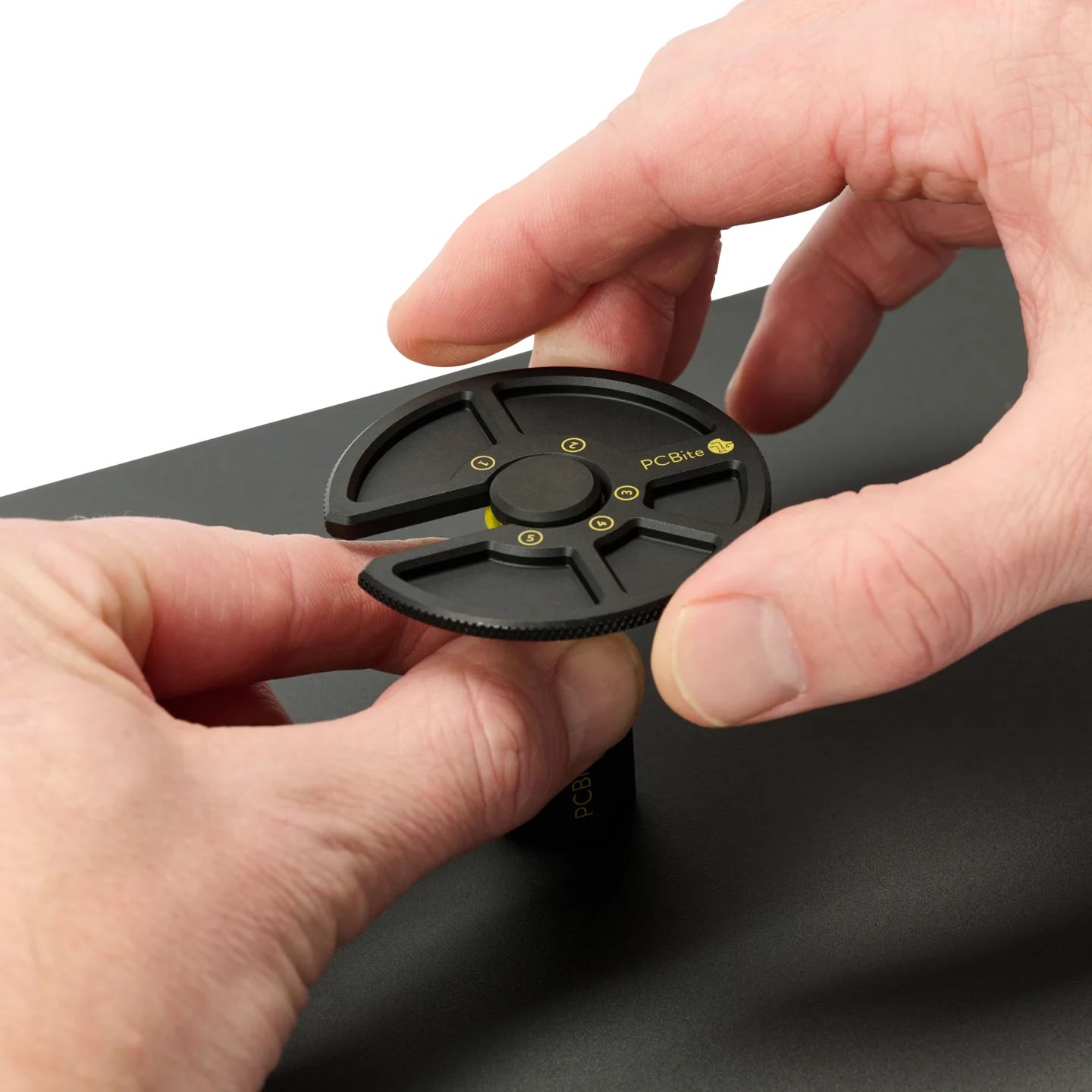 Hand closing PCB holder while another releases the component tray locked into position (PCBITE-7029)