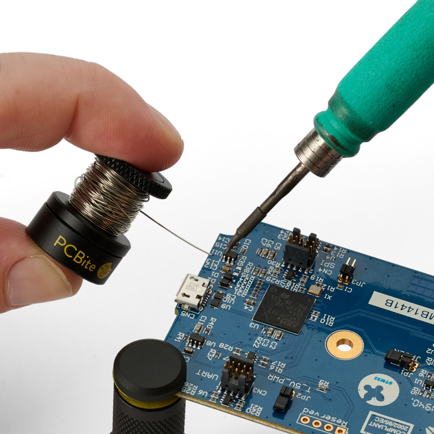 Hand holding the small wire stand when soldering on PCB (PCBITE-7030)