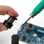 Hand holding the small wire stand when soldering on PCB (PCBITE-7030)