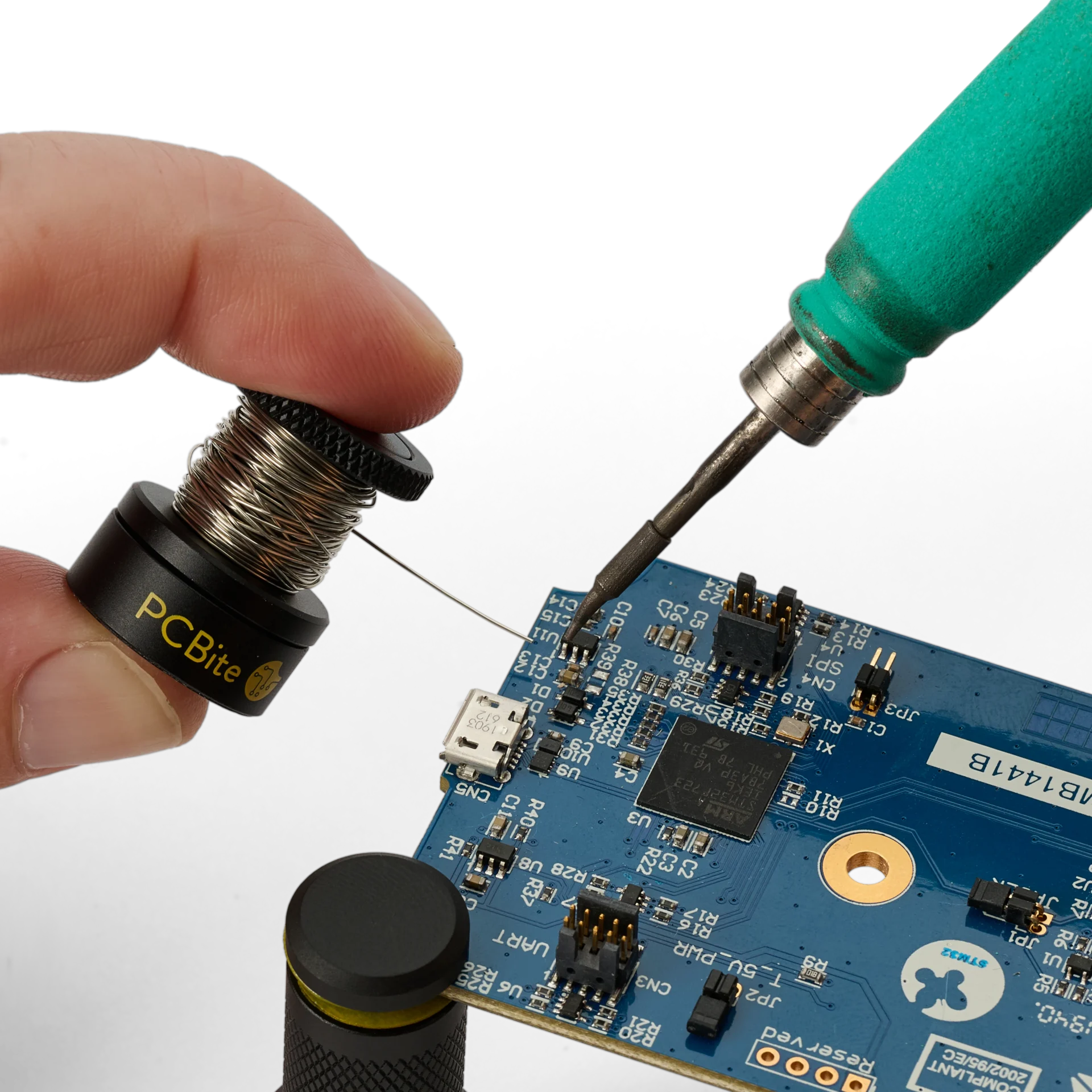 Hand holding the small wire stand when soldering on PCB (PCBITE-7030)