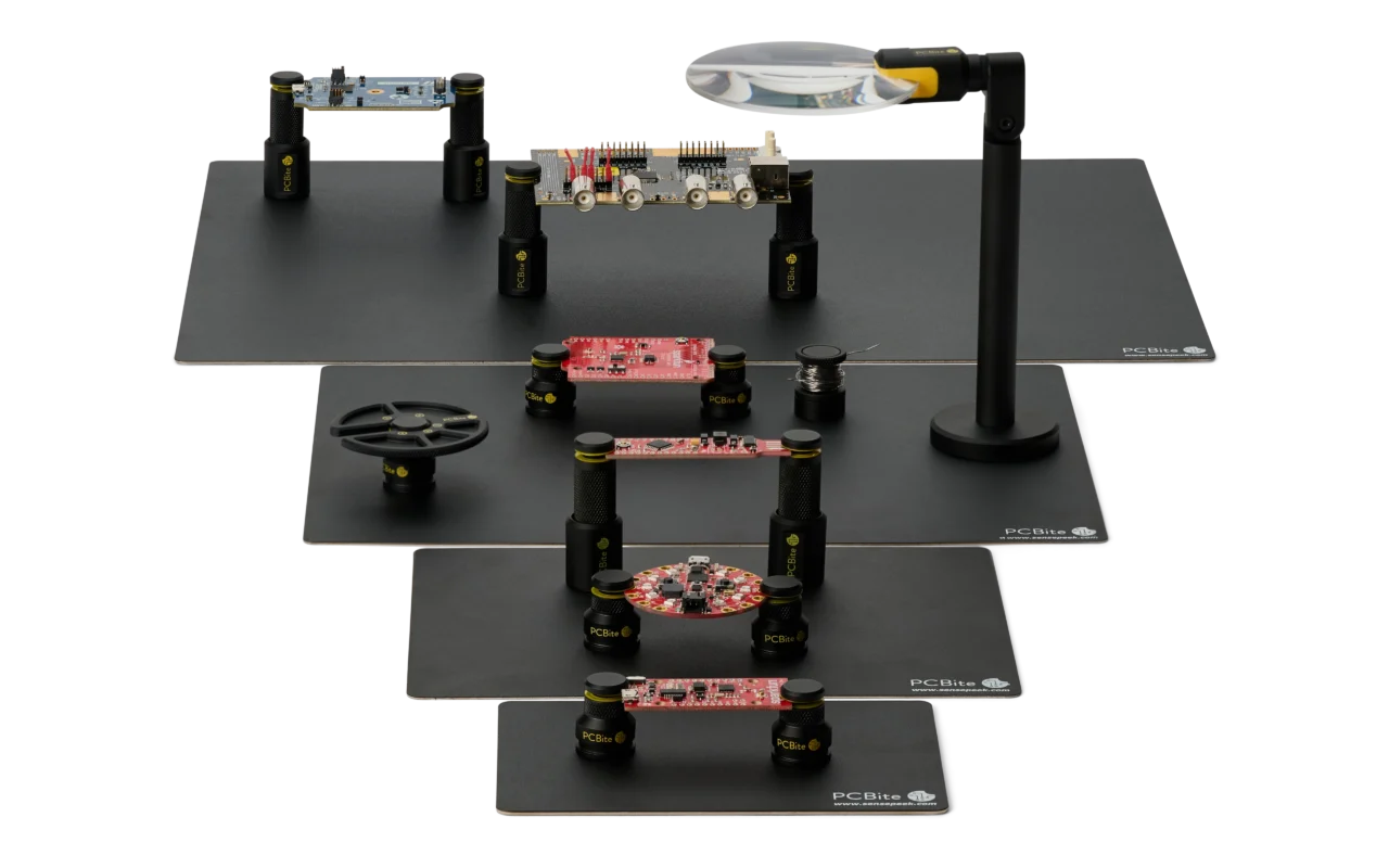 PCBite base plates from XS to XL, each with PCB holders on it, plus a magnifier, a component tray and a solder wire stand.