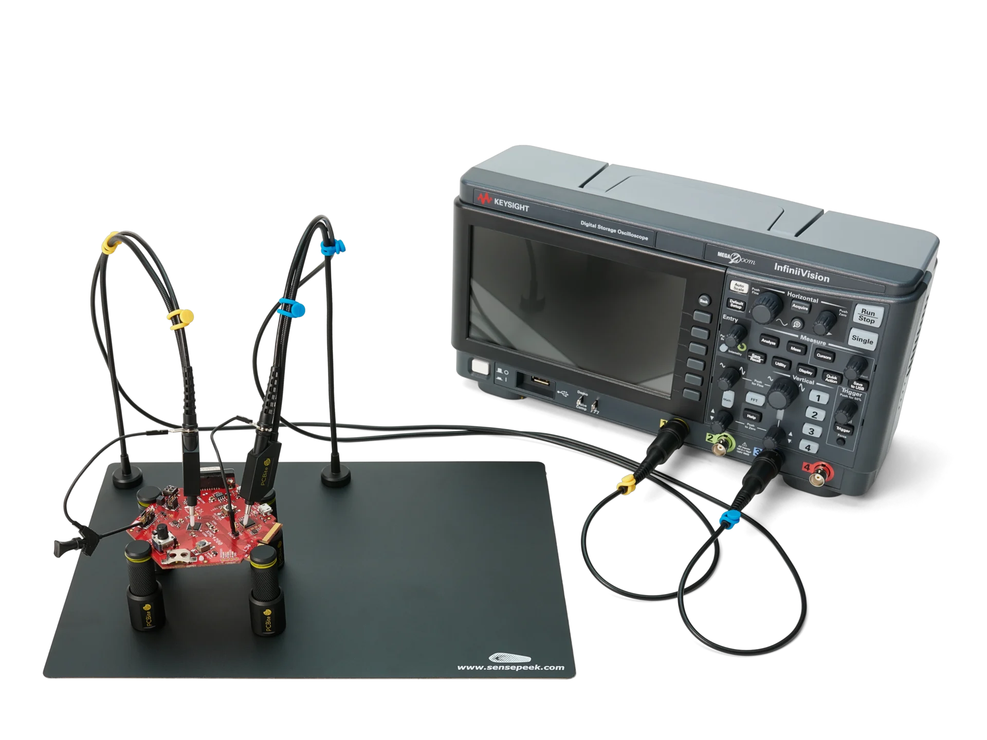 Two handsfree oscilloscope probes on a PCB held by PCBite holders, connected over BNC to a Keysight oscilloscope.