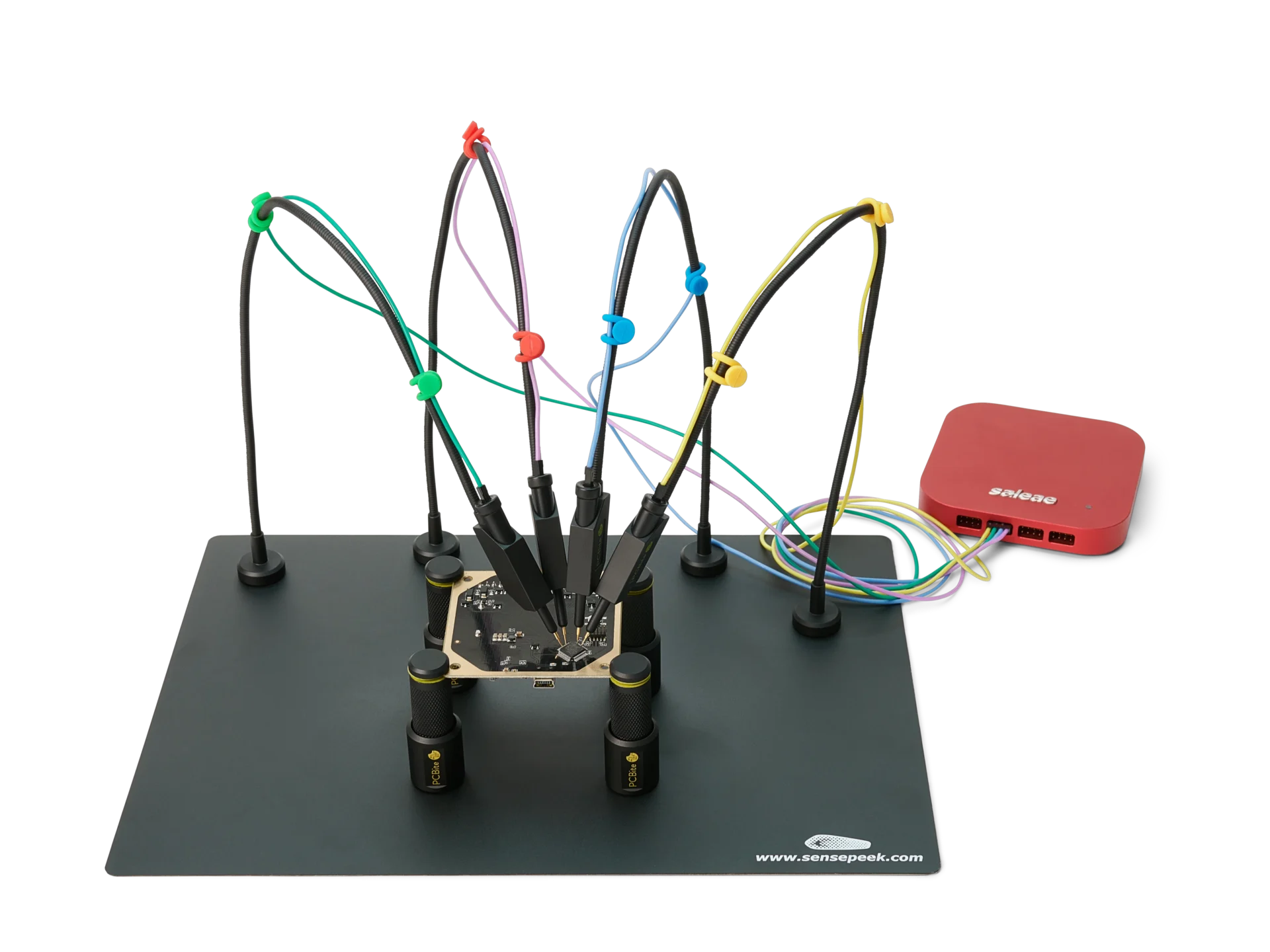 Four handsfree SQ10 probes with color-coded cable holders measuring finepitch IC on PCB