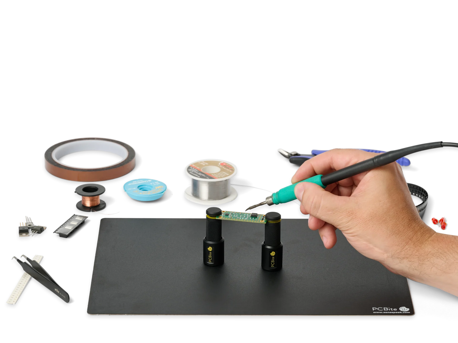 Hand soldering a small PCB held by two magnetic PCBite holders on a base plate, with full access to the pads.
