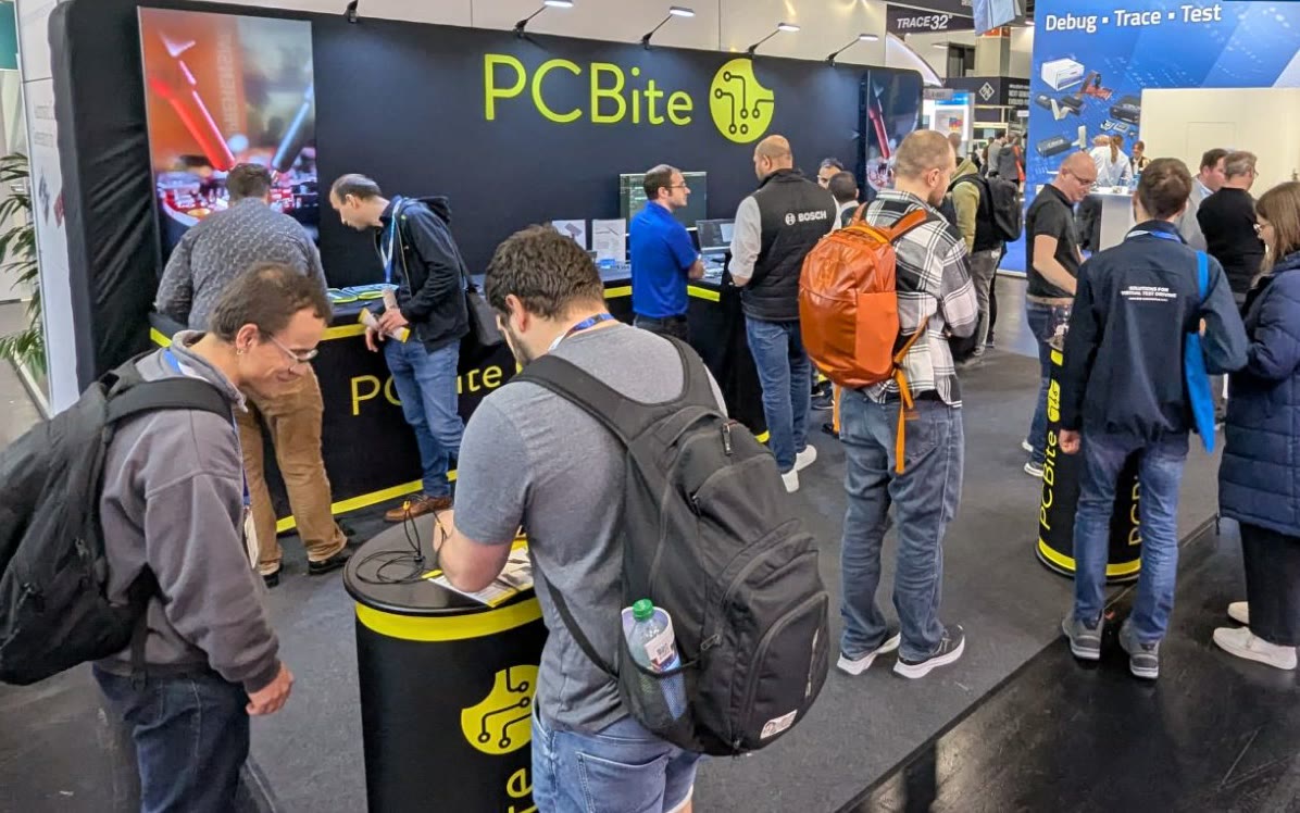 Visitors trying PCBite at the booth in Hall 4 at Embedded World 2025 in Nuremberg.